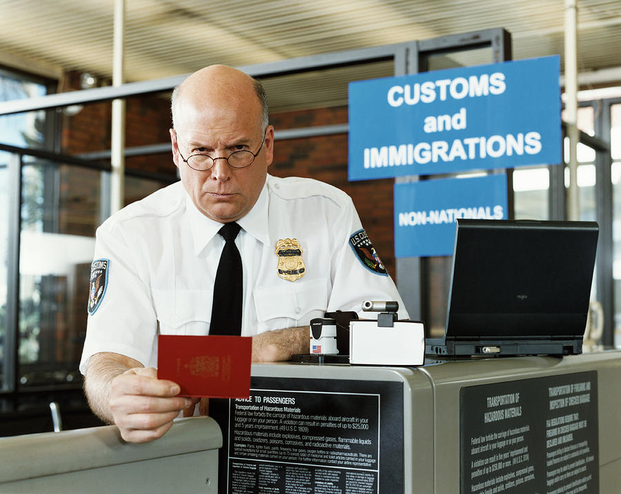 Passport Officer at Airport Security #1 Photograph by Digital Vision.