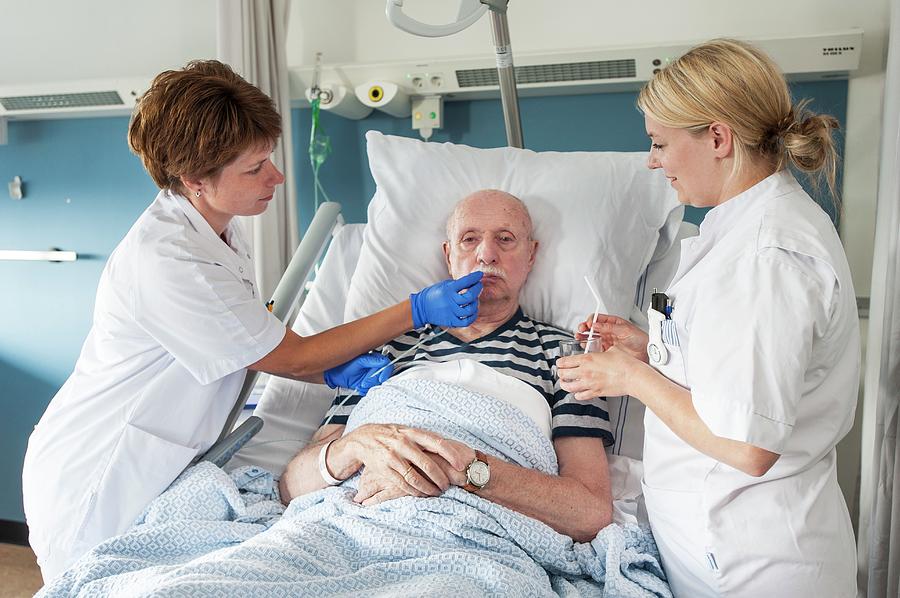 Patient With Nurses #1 Photograph by Arno Massee/science Photo Library ...