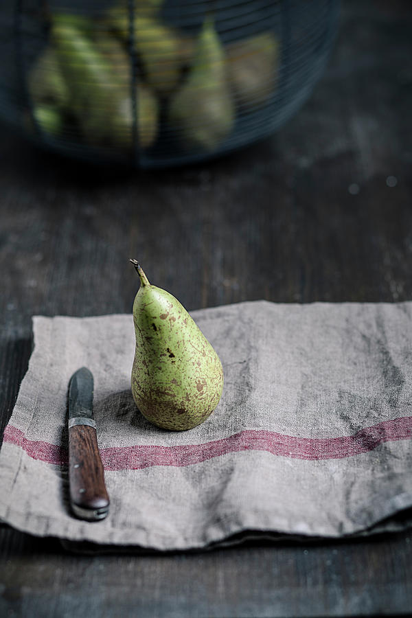 Pear With Water Trops And Knife On #1 Photograph by Westend61