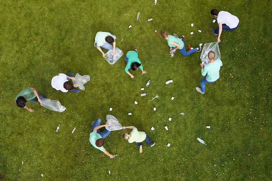 People cleaning up litter on grass #1 Photograph by Photo_Concepts