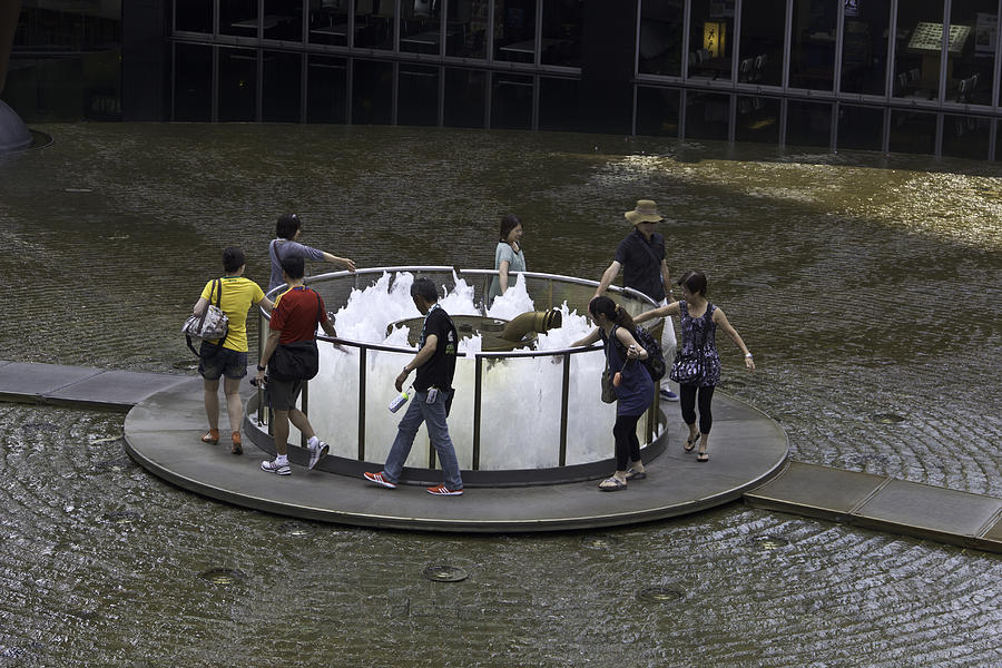 People walking around the Fountain of Wealth in Singapore #1 Photograph by Ashish Agarwal