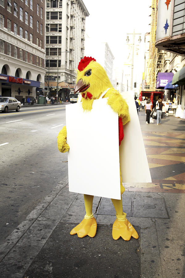 Person in chicken costume wearing a signboard #1 Photograph by Eric Chuang