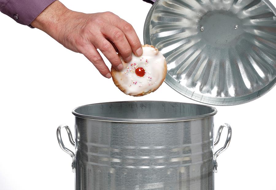 Cake Photograph - Person Throwing Cake Into Dustbin #1 by Victor De Schwanberg/science Photo Library