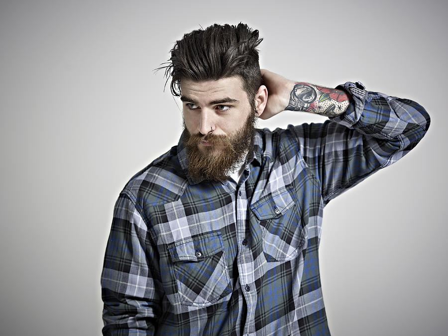 Portrait of man with beard, tattoos & check shirt. #1 Photograph by Mike Harrington