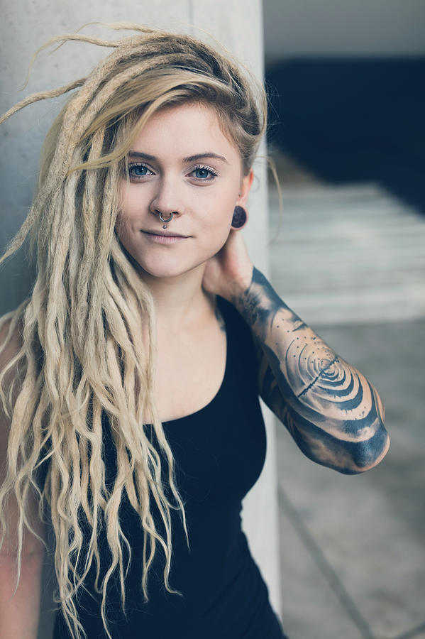Portrait of tattooed and pierced young women with blond dreadlocks #1 Photograph by Kamisoka
