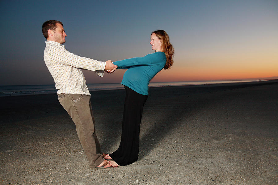 Sunset Photograph - Pregnant Couple Pose On The Shore #1 by Logan Mock-Bunting