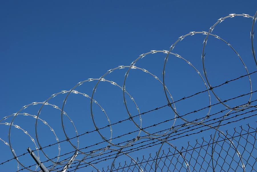 Razor Wire Fence In Las Vegas Photograph by Mark Williamson/science Photo Library