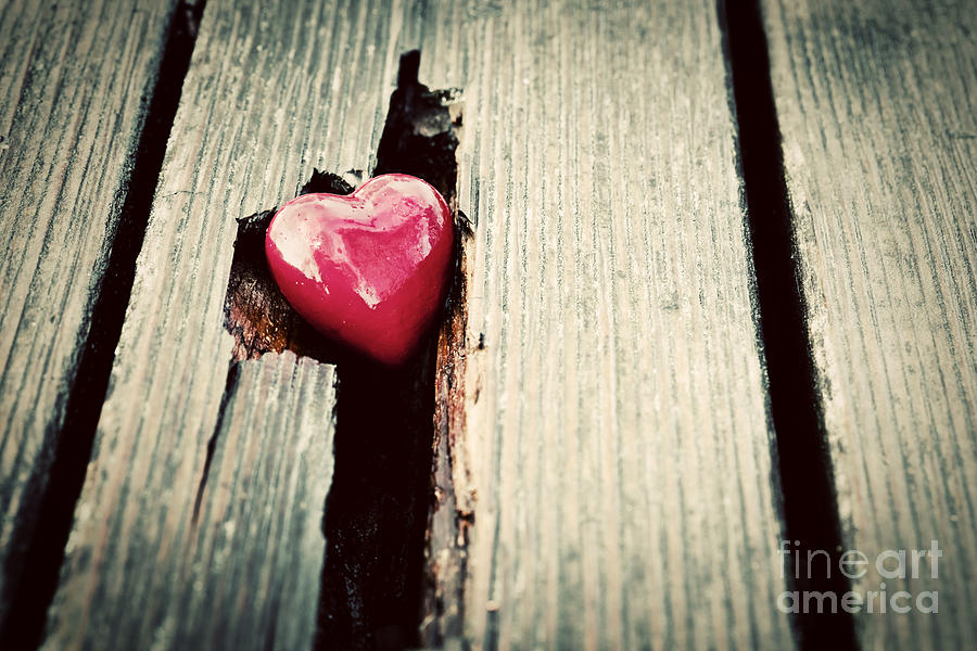 Red heart in crack of wooden plank #1 Photograph by Michal Bednarek