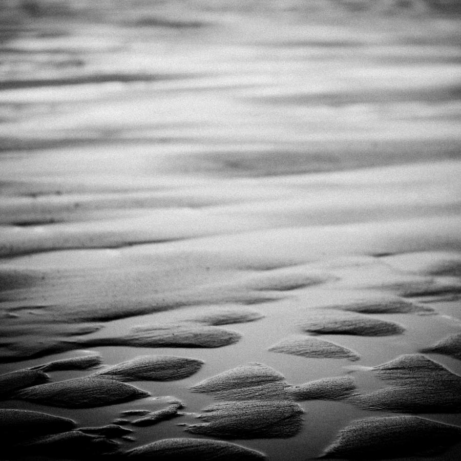 Rythm on sand with wave on sea coast at sunset #1 Photograph by Raimond Klavins