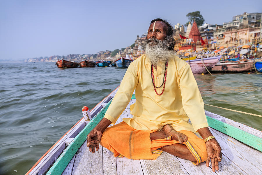 Sadhu is meditating in boat on Holy Ganges River, Varanasi #1 Photograph by Hadynyah