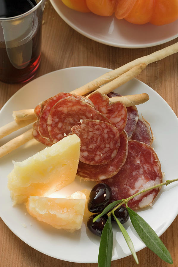 Salami, Cheese, Olives And Grissini On Plate Photograph by ...