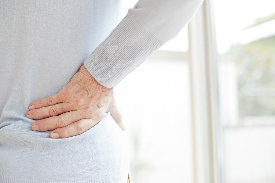 Senior Woman Rubbing Sore Back Photograph by Science Photo Library ...