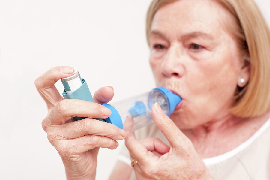 Senior Woman Using An Inhaler Photograph by Science Photo Library