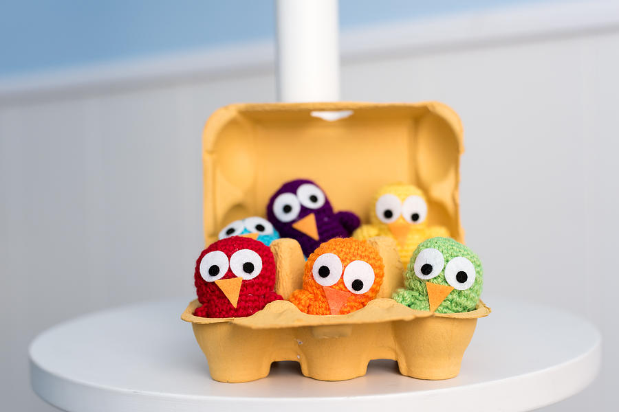 Six handmade crocheted chicks in an egg-cup #1 Photograph by Click&Boo