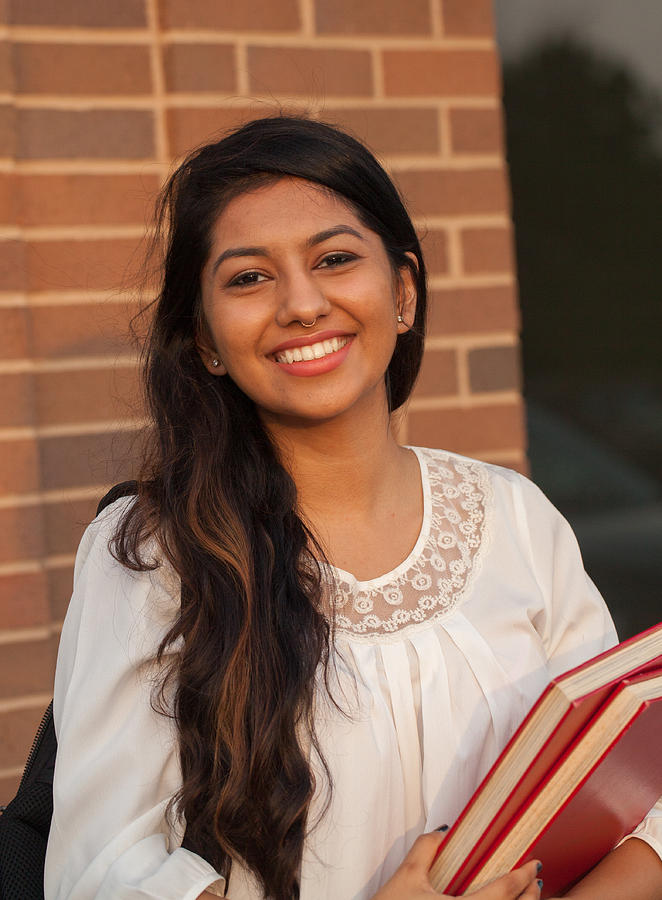 Smiling female young college student of Indian ethnicity #1 Photograph by XiFotos