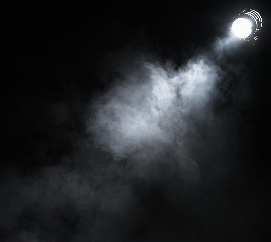Smoke beneath spotlight #1 Photograph by Ryan McVay