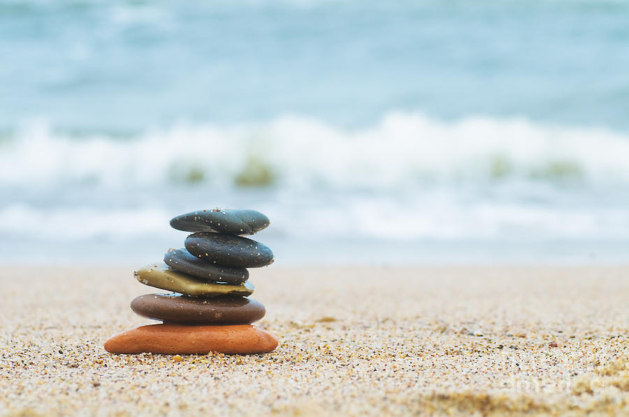 Stack Of Beach Stones On Sand Photograph