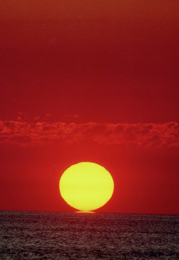 Sun Setting Over The Ocean #1 Photograph by Ron Reid/science Photo Library.