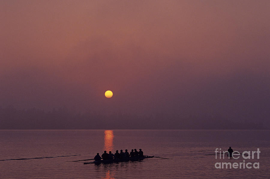 Sunrise on the Montlake Cut with eight man crew rowing on calm w #1 Photograph by Jim Corwin