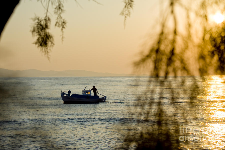 Sunset boat at sea #1 Photograph by Raimond Klavins