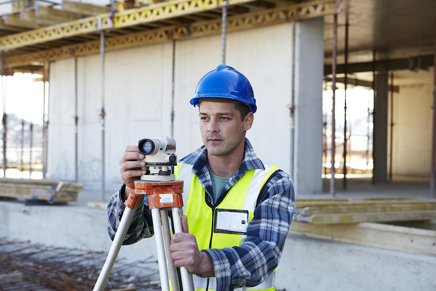 Surveyor on building site #1 Photograph by Alistair Berg