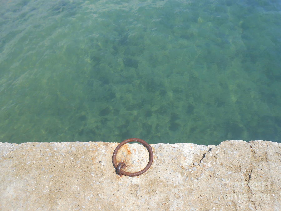 Teal Waters And A Rusty Ring In A Dock Photograph