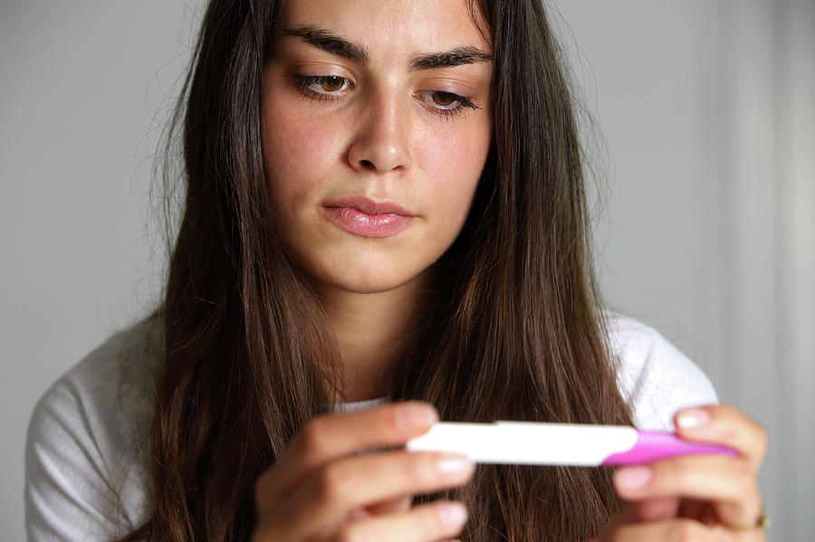 Teenage Girl With A Pregnancy Test #1 Photograph by Mauro Fermariello