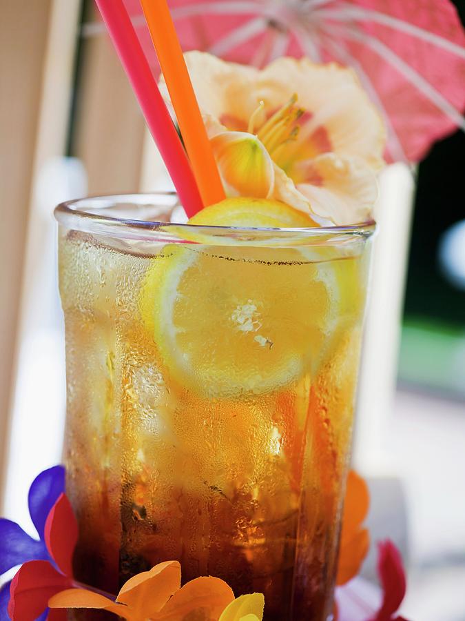 Tequila Sunrise With Ice Cubes And Lemon Photograph by Foodcollection