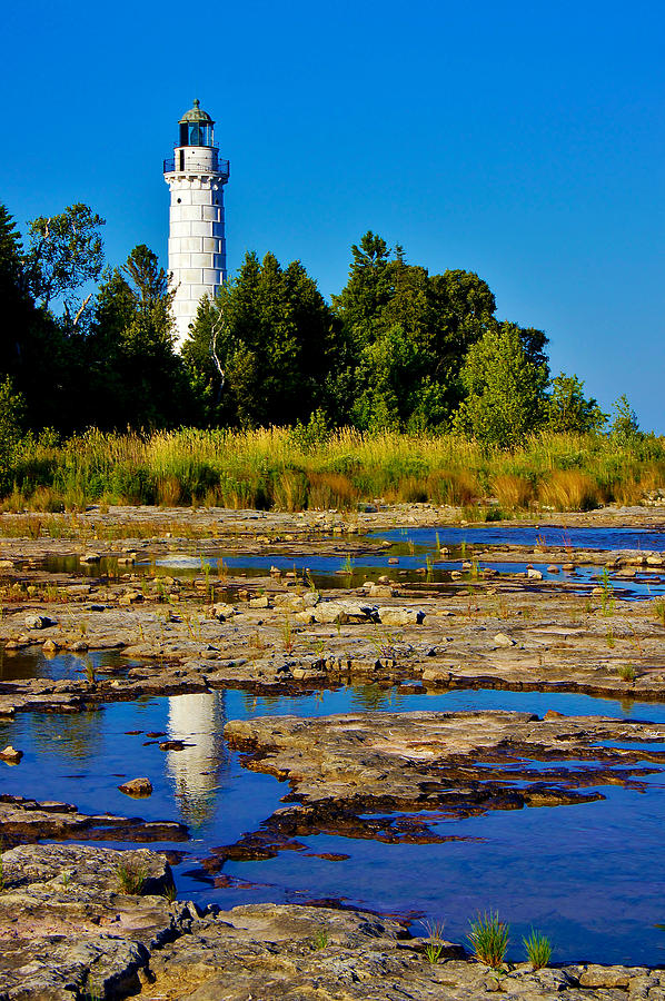 The Cana Island Lighthouse in Baileys Harbor Reflective waters ...