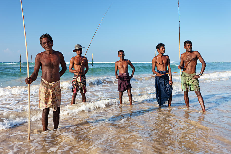 The Stilt Fishermen At Work, Sri Lanka #1 Photograph by Hadynyah