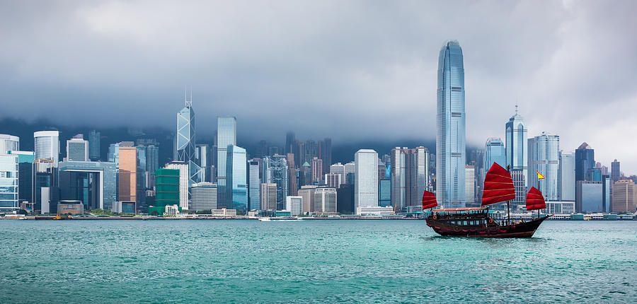 Traditional Chinese Junkboat Sailing Across Victoria Harbour, Hong Kong #1 Photograph by Onfokus