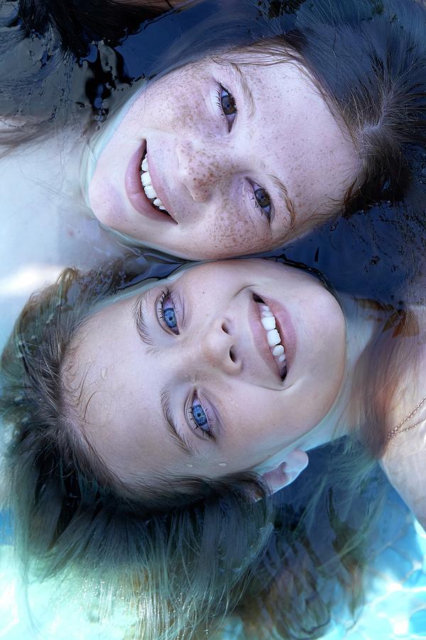 Two Girls Floating In Water #1 Photograph by Ruth Jenkinson