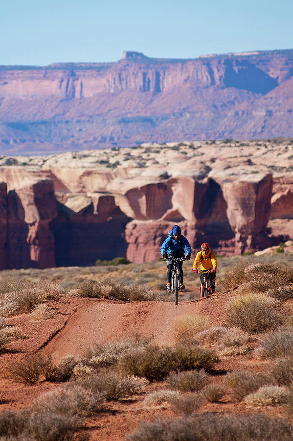 Canyonlands National Park Photograph - Two Men Mountain Biking In The Desert #1 by Celin Serbo