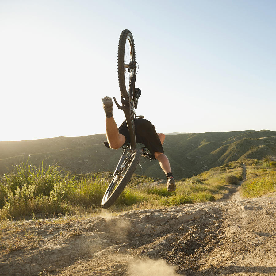 USA, California, Laguna Beach, Mountain biker falling of his bike #1 Photograph by Tetra Images - Erik Isakson