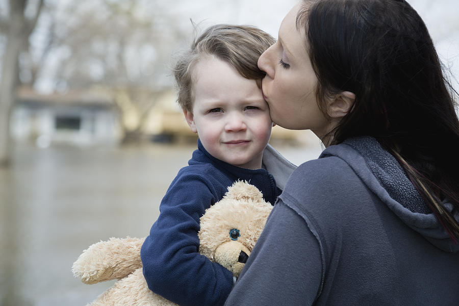 USA, Illinois, Mother with son standing in flooded town #1 Photograph by Greg Vote