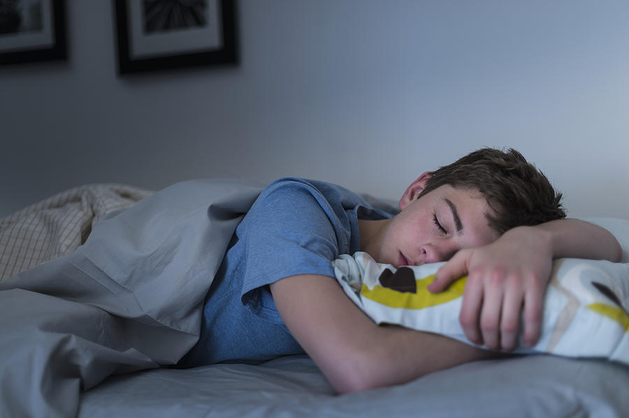 USA, New Jersey, Jersey City, Teenage boy (16-17) sleeping in bed Photograph by Tetra Images
