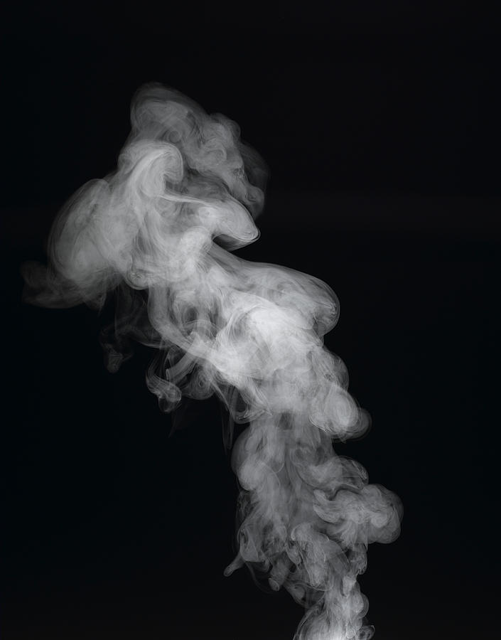 Vapour rising against dark background #1 Photograph by Jeffrey Coolidge