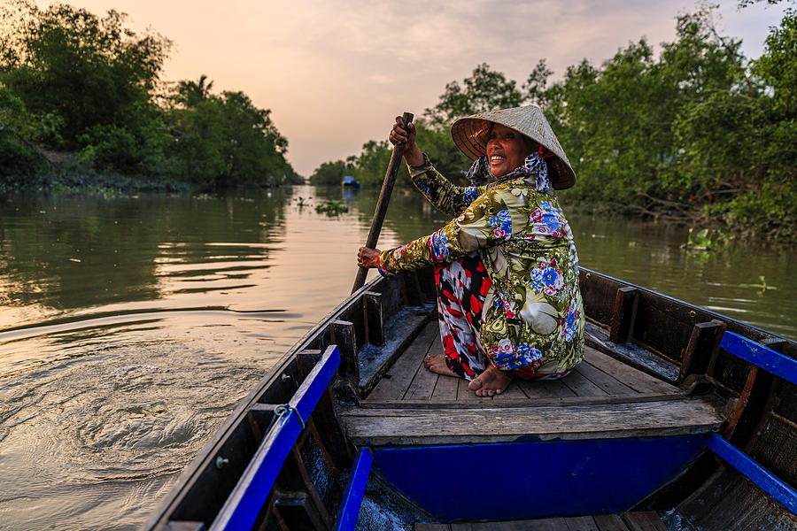 Vietnamese woman rowing a boat, Mekong River Delta, Vietnam #1 Photograph by Hadynyah