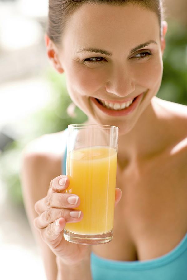 Woman Drinking Juice Photograph By Ian Hooton Science Photo Library