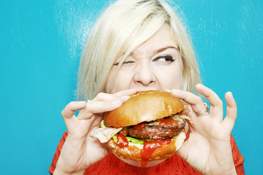 Woman Eating Hamburger #1 Photograph by Tara Moore