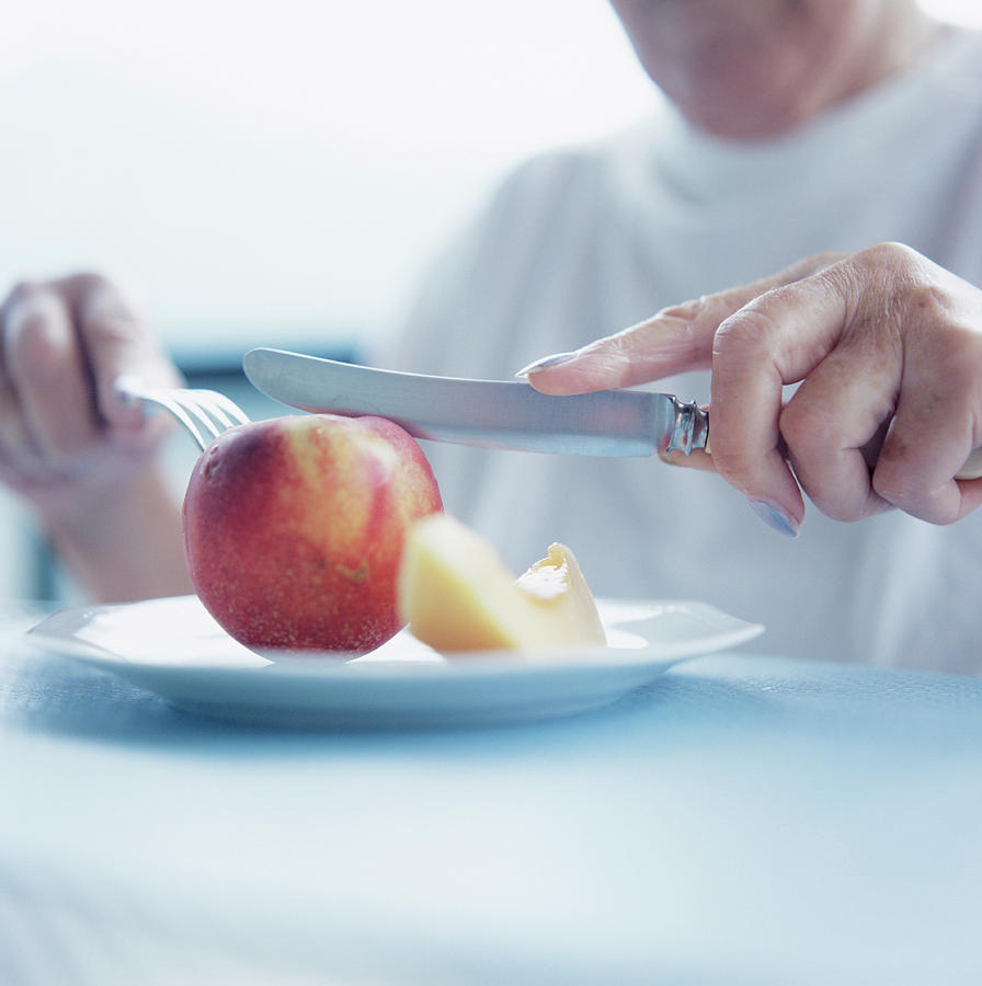 Woman Eating Nectarine #1 by Science Photo Library