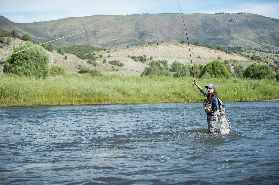 Woman Fishing In River, Colorado, Usa Photograph by Jennifer Magnuson ...