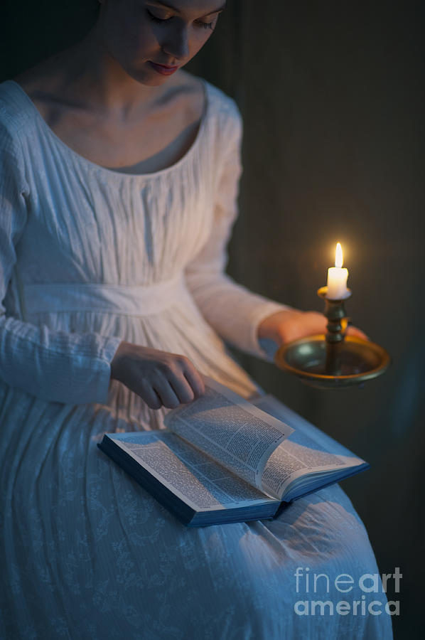 Woman In A Regency Period Dress Reading A Book By Candlelight  #1 Photograph by Lee Avison