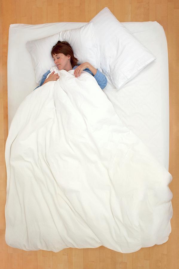 Woman Lying In Bed Holding Duvet Photograph By Ian Hootonscience Photo Library Fine Art America