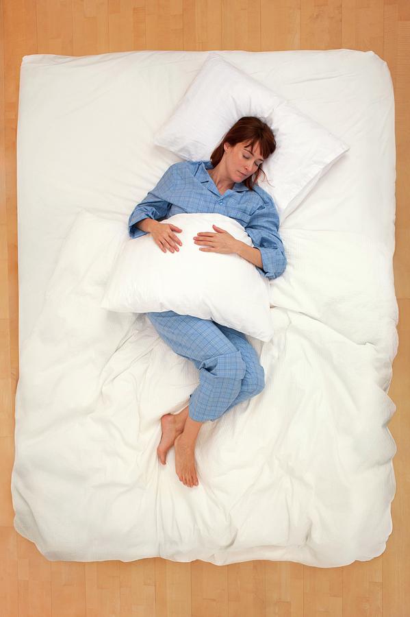 Woman Lying In Bed Holding Pillow Photograph By Ian Hootonscience Photo Library Pixels