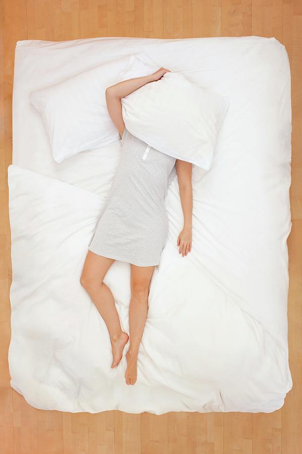 Woman Lying In Bed With Pillow Over Head Photograph By Ian Hootonscience Photo Library Pixels