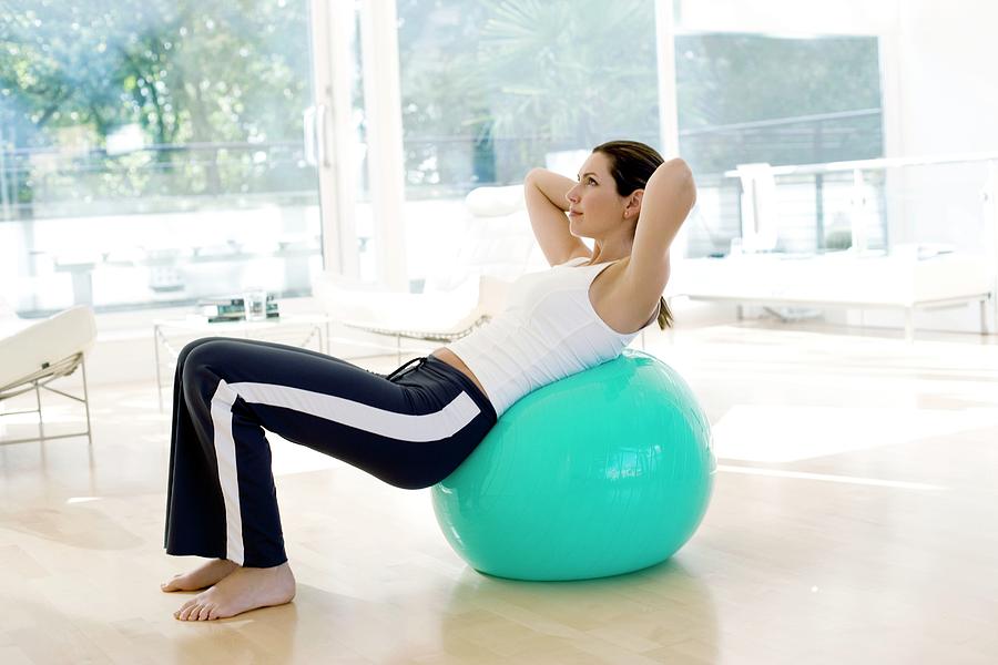 Ball Photograph - Woman Using Exercise Ball #1 by Ian Hooton/science Photo Library