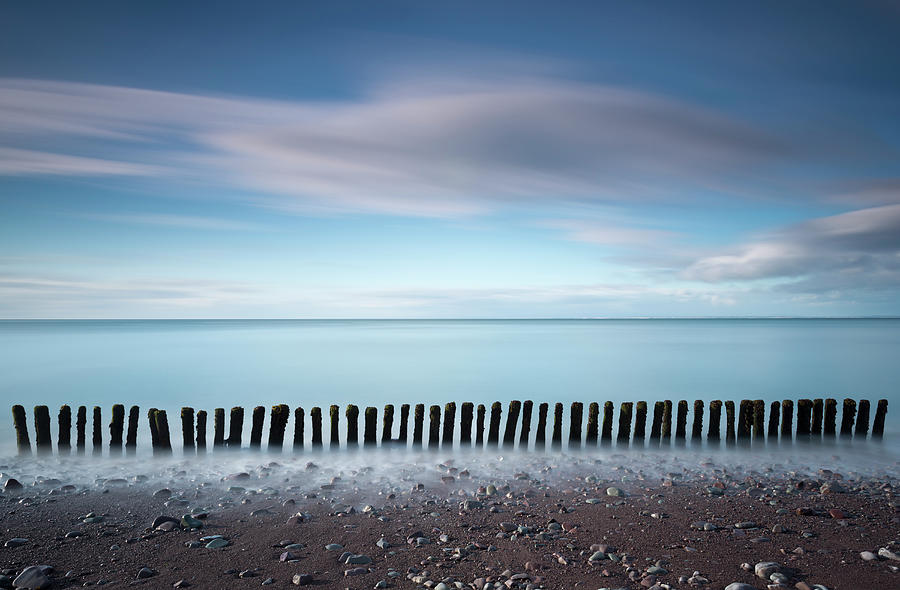 Wooden Groynes On A Beach At Low Tide #1 Photograph by Jeremy Walker
