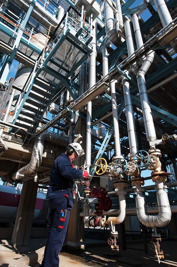 Worker Checking Pipework On An Oil And Gas Refinery #1 Photograph by Christian Lagerek/science Photo Library
