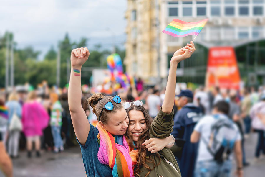 Young adult female couple  at pride parade #1 Photograph by Stock-eye